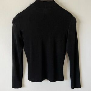 PIA USA woman’s long sleeved black polyester blend top, appears a size S